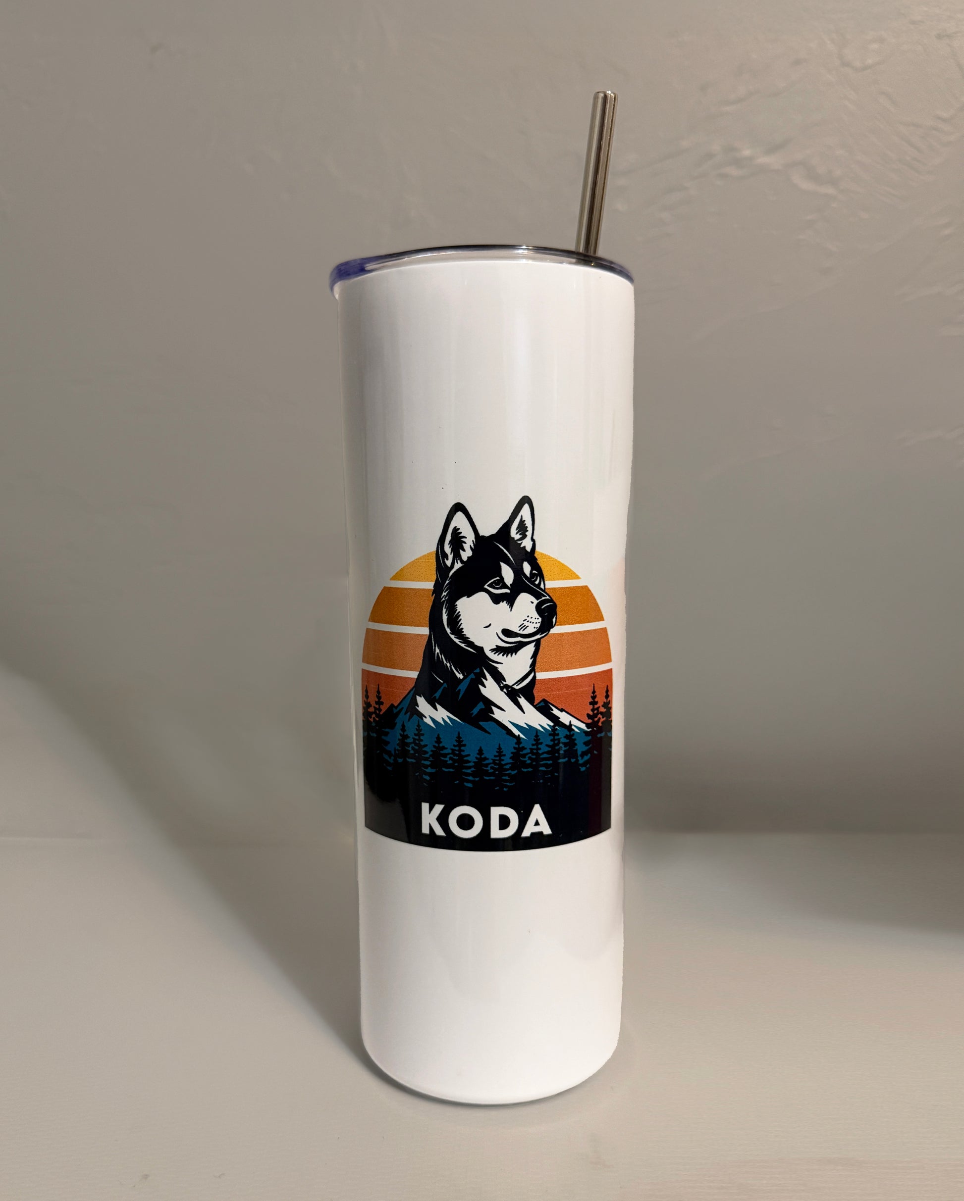 White tumbler with a dog illustration and 'KODA' text on a plain background